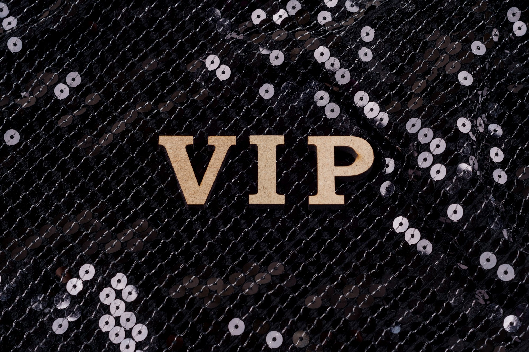 VIP is written in abstract letters. Black luxurious sparkling background